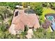 Aerial view of a grand home with brick driveway, tile roof, and manicured landscaping at 1502 Hempel Ave, Windermere, FL 34786