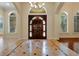 Inviting foyer with elegant tile flooring, arched windows, and a grand double-door entrance at 1502 Hempel Ave, Windermere, FL 34786