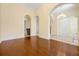 Spacious foyer with hardwood floors, arched entryway, and ample natural light at 1502 Hempel Ave, Windermere, FL 34786