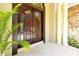 Close-up of the stunning double front door, highlighting the arched design and hardware at 1502 Hempel Ave, Windermere, FL 34786
