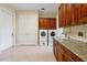 Laundry room with built in cabinets, sink, folding area and appliances at 1502 Hempel Ave, Windermere, FL 34786