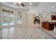Bright, open-plan living room with French doors and views of the pool area at 1502 Hempel Ave, Windermere, FL 34786