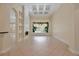 Bright living room featuring high ceilings, tile floors, a fireplace, and a large window overlooking the yard at 1502 Hempel Ave, Windermere, FL 34786
