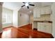 A living room featuring hardwood floors, natural light, and a wet bar for convenience at 1502 Hempel Ave, Windermere, FL 34786