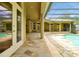The patio offers a serene escape with a pool, stone flooring, and a screened-in enclosure at 1502 Hempel Ave, Windermere, FL 34786