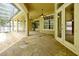 Expansive covered patio featuring stone flooring, ceiling fans, and views of the screened-in pool area at 1502 Hempel Ave, Windermere, FL 34786