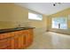A utility room includes custom cabinets, a sink, and windows providing ample natural light at 1502 Hempel Ave, Windermere, FL 34786