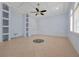 An open living space is bright with a tile floor, built-in shelves, and abundant natural light at 1502 Hempel Ave, Windermere, FL 34786