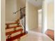 Staircase with decorative wrought iron, wood railing, and tiled steps leading to the upper floor at 1502 Hempel Ave, Windermere, FL 34786