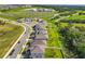 New homes line a street in a Primary-planned community with green spaces and a school nearby at 2044 Keystone Pass Blvd, Minneola, FL 34715