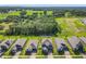 Expansive aerial view of the home and neighborhood features a vast green space at 2044 Keystone Pass Blvd, Minneola, FL 34715