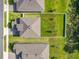 Aerial view of home with a large, fenced backyard featuring green grass and young trees at 2044 Keystone Pass Blvd, Minneola, FL 34715