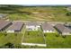 Aerial view of a backyard with a white fence, green grass and a patio with outdoor furniture at 2044 Keystone Pass Blvd, Minneola, FL 34715