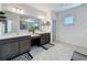 Modern bathroom features double vanities, a large mirror, and contemporary fixtures for a spa-like experience at 2044 Keystone Pass Blvd, Minneola, FL 34715