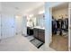 Luxurious bathroom with dual vanities, a walk-in closet, and contemporary finishes for a spa-like retreat at 2044 Keystone Pass Blvd, Minneola, FL 34715
