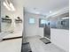 Bright bathroom with double vanity, decorative mirror, and glass-enclosed shower featuring gray tiles at 2044 Keystone Pass Blvd, Minneola, FL 34715