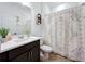 Clean bathroom with single sink vanity, shower-tub combo and decorative patterned shower curtain at 2044 Keystone Pass Blvd, Minneola, FL 34715