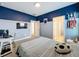 Comfortable bedroom featuring a bed, desk, mounted TV, and athletic-themed decorations at 2044 Keystone Pass Blvd, Minneola, FL 34715