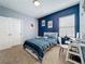 Bright bedroom with desk, full bed, and two-tone walls, perfect for a sports lover at 2044 Keystone Pass Blvd, Minneola, FL 34715