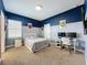 Spacious bedroom with a bed, desk, two-tone walls, and decor for a sports enthusiast at 2044 Keystone Pass Blvd, Minneola, FL 34715