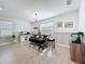 Bright dining room with decorative lighting, wainscotting, and a rustic table with a bench at 2044 Keystone Pass Blvd, Minneola, FL 34715