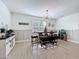Dining room with modern lighting, wainscotting, and a rustic table with bench seating at 2044 Keystone Pass Blvd, Minneola, FL 34715