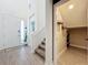 Entrance featuring tile flooring, a white front door, and a carpeted staircase in the foyer area at 2044 Keystone Pass Blvd, Minneola, FL 34715