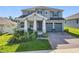 Charming two-story home boasts a manicured lawn and a two-car garage at 2044 Keystone Pass Blvd, Minneola, FL 34715