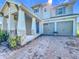 Charming two-story home boasts a manicured lawn and a two-car garage at 2044 Keystone Pass Blvd, Minneola, FL 34715