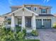 Charming two-story home featuring a two-car garage, well-manicured landscaping, and inviting front porch at 2044 Keystone Pass Blvd, Minneola, FL 34715