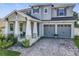 Charming two-story home boasts a manicured lawn and a two-car garage at 2044 Keystone Pass Blvd, Minneola, FL 34715