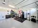 Garage with exercise equipment, storage shelving, and epoxy flooring at 2044 Keystone Pass Blvd, Minneola, FL 34715