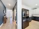 Hallway view leading into kitchen, showcasing tile flooring and elegant color scheme at 2044 Keystone Pass Blvd, Minneola, FL 34715