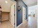 Hallway with wood-look tile floors and a flex space, connecting to the dining area in this home at 2044 Keystone Pass Blvd, Minneola, FL 34715