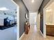 Inviting hallway leading to a garage gym, bathroom, and entryway at 2044 Keystone Pass Blvd, Minneola, FL 34715