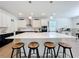 Open-concept kitchen featuring a large island with barstool seating and modern stainless steel appliances at 2044 Keystone Pass Blvd, Minneola, FL 34715