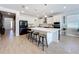Modern kitchen featuring stainless steel appliances, barstool seating and a large central island at 2044 Keystone Pass Blvd, Minneola, FL 34715