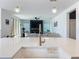 Bright, white kitchen featuring a large island with quartz countertops and a gold faucet at 2044 Keystone Pass Blvd, Minneola, FL 34715