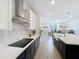 Modern kitchen with stainless steel appliances, white cabinets, and a white backsplash at 2044 Keystone Pass Blvd, Minneola, FL 34715