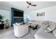 Open living room featuring a stylish fireplace, ceiling fan, tile floor, and ample seating at 2044 Keystone Pass Blvd, Minneola, FL 34715