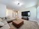 Stylish living room offering plush seating, neutral decor, and a large-screen TV for comfortable entertaining at 2044 Keystone Pass Blvd, Minneola, FL 34715