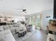 Bright living room leading to kitchen featuring an open floor plan and lots of natural light at 2044 Keystone Pass Blvd, Minneola, FL 34715