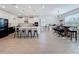 Open-concept kitchen and dining space with dark appliances, light flooring, and barstool seating at 2044 Keystone Pass Blvd, Minneola, FL 34715