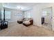 Cozy loft with brown sectional, television and doorway to the laundry room at 2044 Keystone Pass Blvd, Minneola, FL 34715