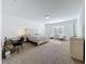 Bright main bedroom with carpeted floor offering neutral tones, a sitting area, and a work area at 2044 Keystone Pass Blvd, Minneola, FL 34715