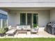 Cozy covered patio with comfortable seating and a grill overlooking the expansive backyard at 2044 Keystone Pass Blvd, Minneola, FL 34715