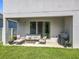 Covered patio with outdoor furniture and a grill, overlooking the grassy backyard at 2044 Keystone Pass Blvd, Minneola, FL 34715