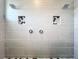 Contemporary shower showcasing sleek gray tiles, dual shower heads, and recessed niches for bath amenities at 2044 Keystone Pass Blvd, Minneola, FL 34715