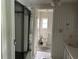 The simple bathroom features neutral walls, a toilet, a sink, and a mirror closet at 24505 Snail Rd, Astor, FL 32102