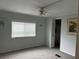 This bedroom includes a neutral gray walls, one window, and a ceiling fan at 24505 Snail Rd, Astor, FL 32102